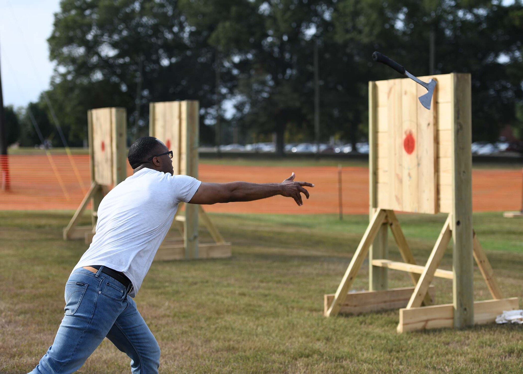 A guy throws an axe at a target