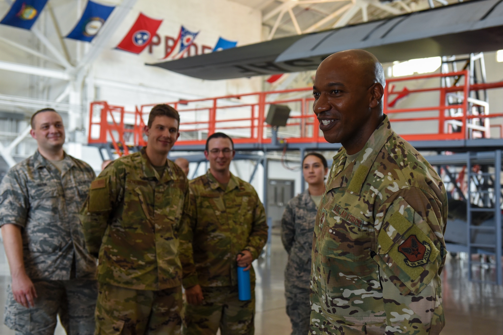 Chief Wright speaks to Airmen in a hangar