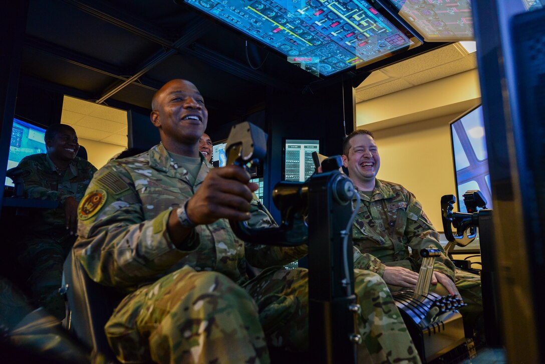 Chief Wright sits in a C-130 flight simulator