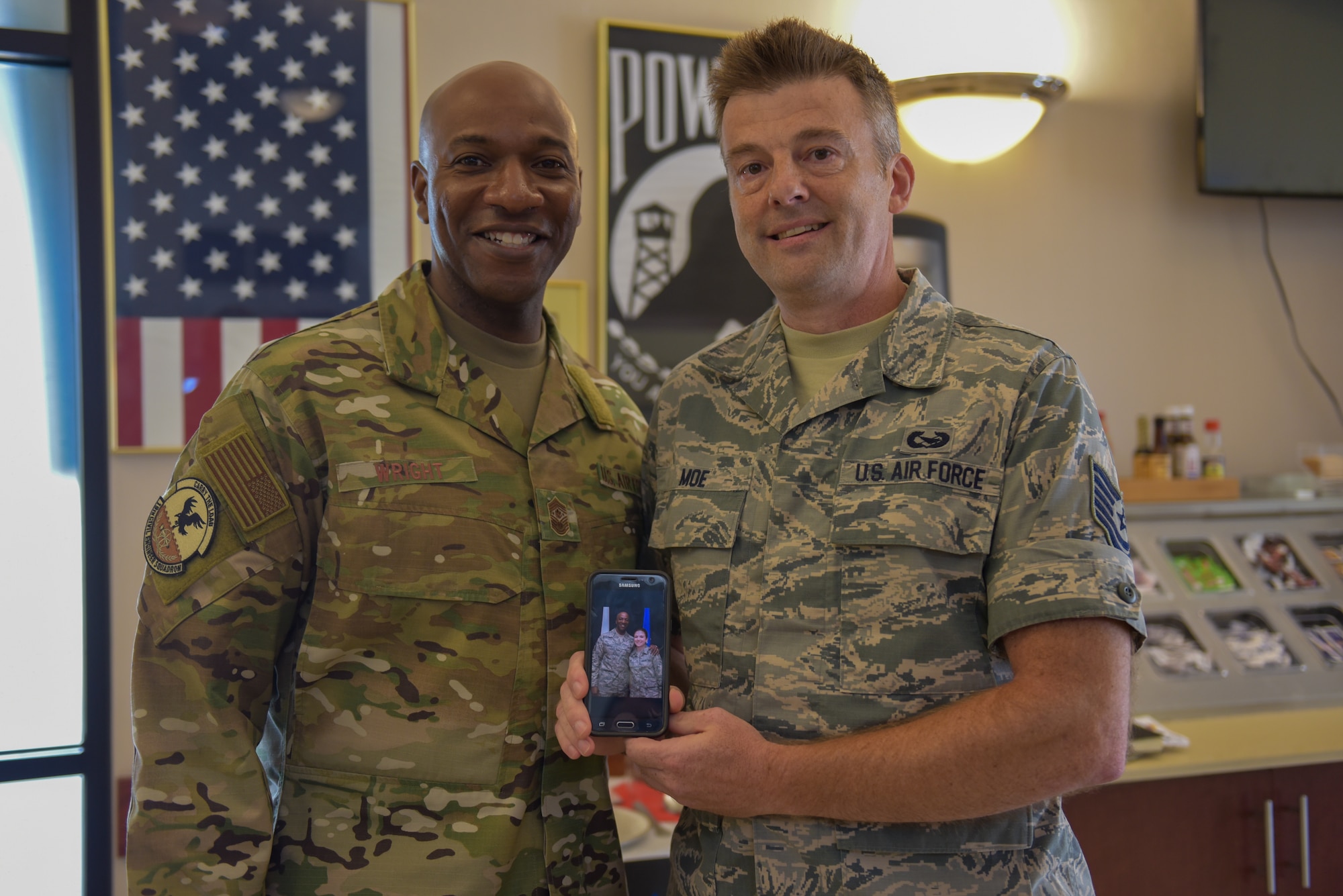 An Airman poses for a photo with Chief Wright