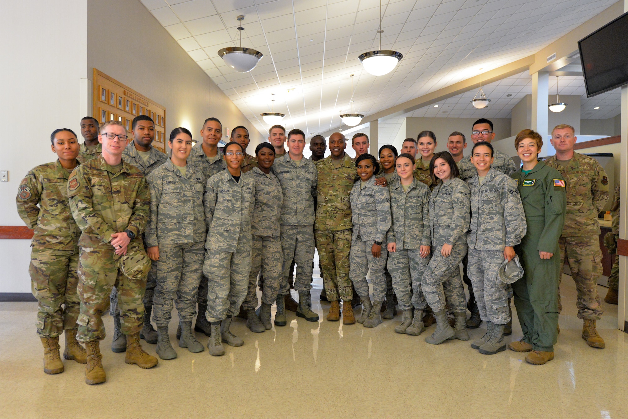 Airman pose for a photo with Chief Wright