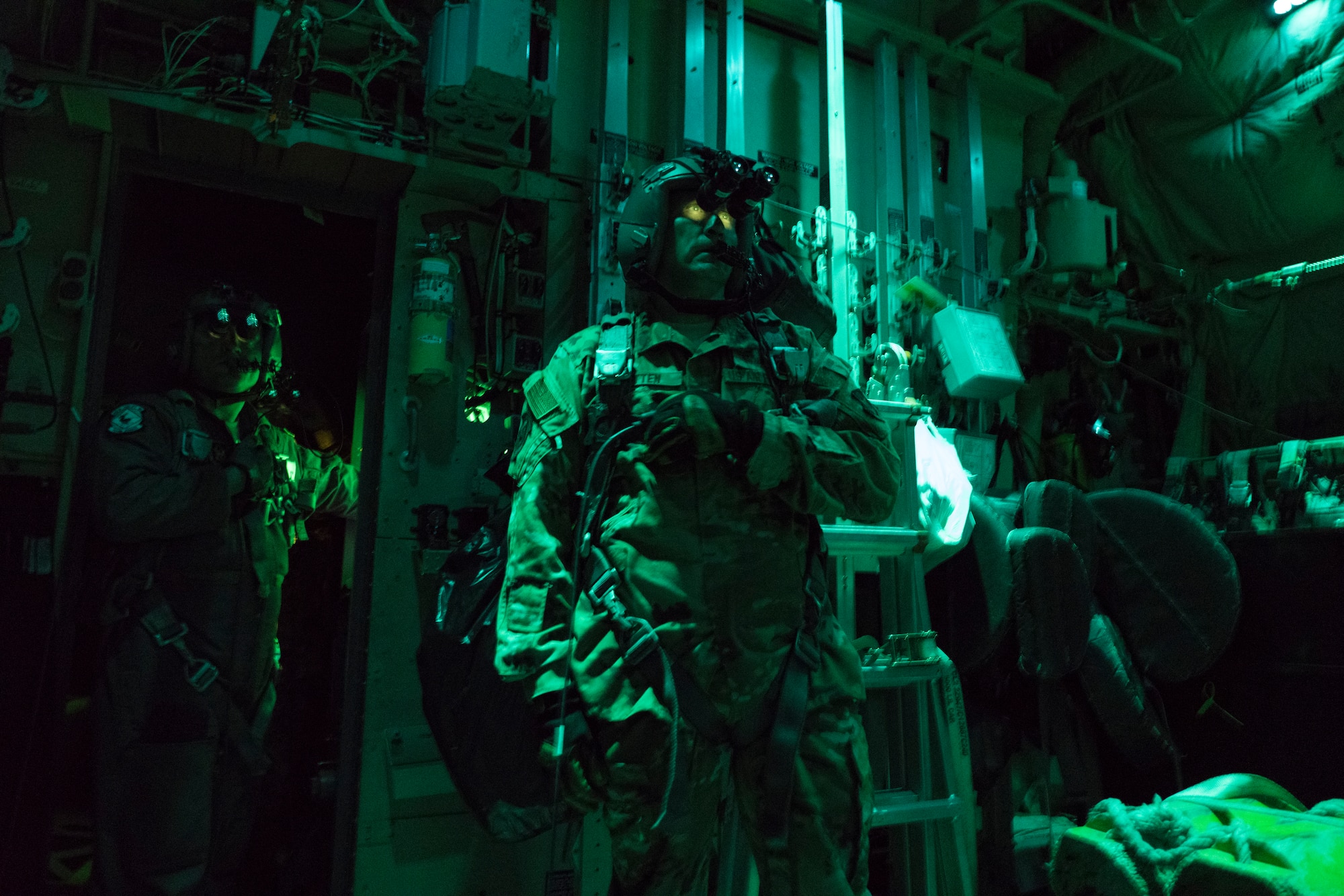 Tech. Sgt. Joel Wilson (left) and Master Sgt. Doug Otten (right), 815th Airlift Squadron loadmasters, watch the ramp of a C-130J Super Hercules open prior to airdrop Oct. 2, 2019 over Camp Shelby Joint Forces Training Center, Miss. The 815th AS, aka ‘Flying Jennies,’ with the 327th AS, provided airlift and airdrop support for the U.S. Army’s Joint Forces Exercise Arctic Anvil, Oct. 1 to 6. (U.S. Air Force photo by Tech. Sgt. Christopher Carranza)