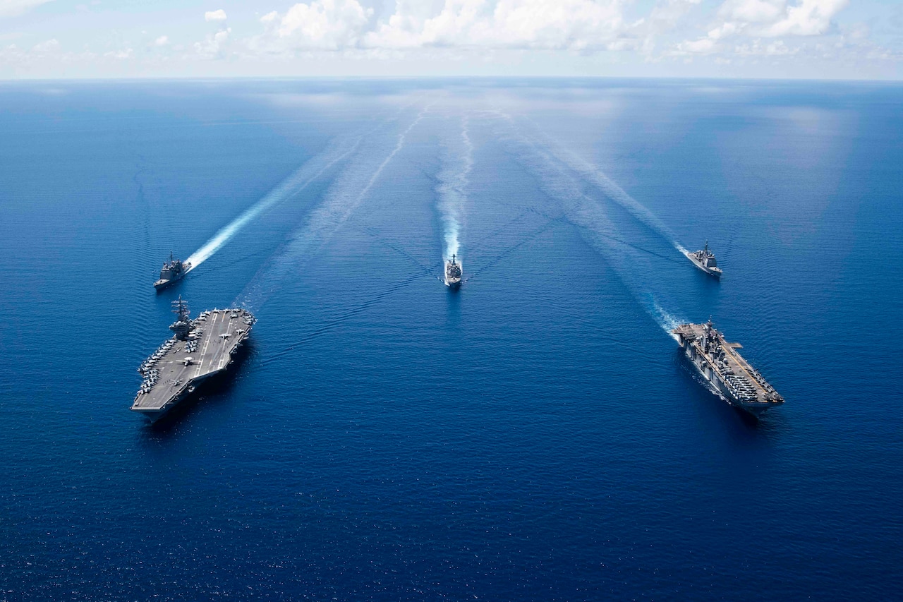 A group of ships sail in formation.