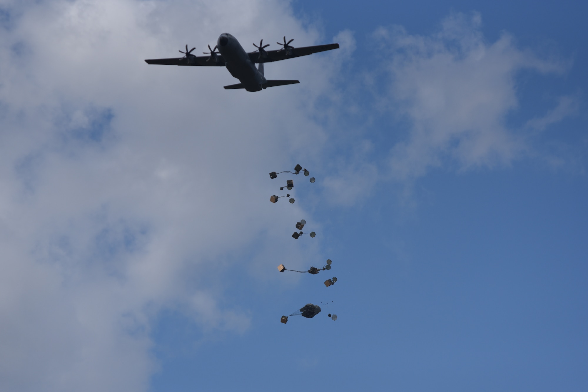 The 815th Airlift Squadron completes an airdrop of container delivery systems during the Army's joint forces exercise Arctic Anvil, Oct. 1-6, over Camp Shelby Joint Forces Training Center, Miss. Reserve Citizen Airmen from the 815th AS assigned to the 403rd Wing at Keesler Air Force Base, Miss., and the 327th AS assigned to the 913th Airlift Group at Little Rock AFB, Ark., provided airlift and airdrop capabilities to the 4th Brigade Combat Team (Airborne), 25th Infantry Division stationed at Joint Base Elmendorf-Richardson, Alaska. (U.S. Air Force photo by Master Sgt. Jessica L. Kendziorek)