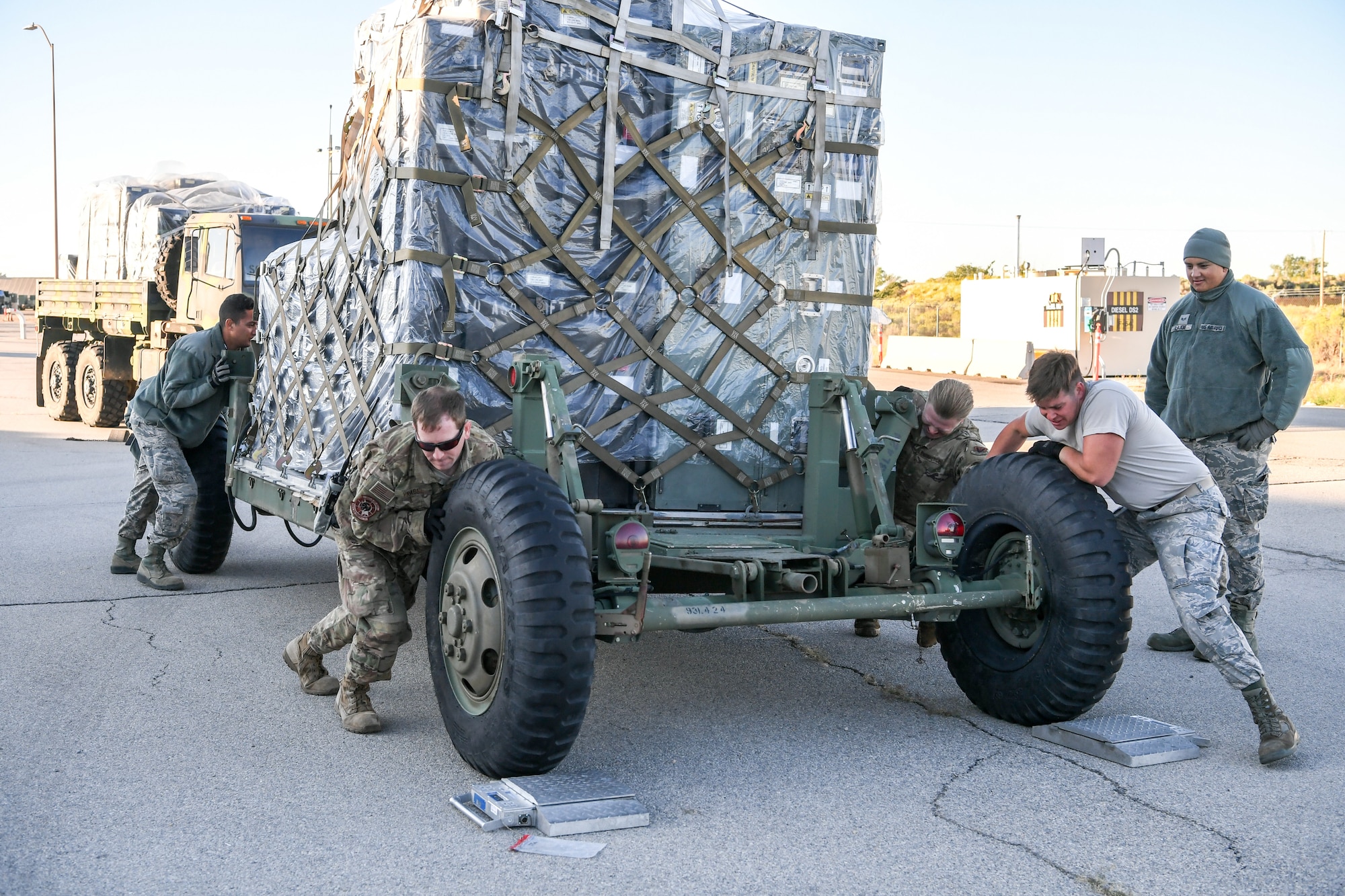 Airmen from 729th Air Control Squadron push a vehicle to be weighed at Hill Air Force Base, Utah, Sept. 13, 2019. The Airmen were preparing to deploy to Wendover Field, Utah, to participate in the squadron’s annual Raging Bull exercise. (U.S. Air Force photo by Cynthia Griggs)