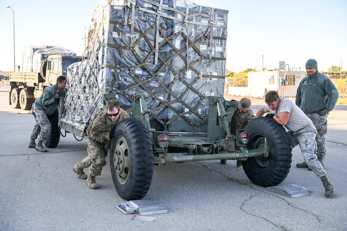 Airmen from 729th Air Control Squadron push a vehicle to be weighed at Hill Air Force Base, Utah, Sept. 13, 2019. The Airmen were preparing to deploy to Wendover Field, Utah, to participate in the squadron’s annual Raging Bull exercise. (U.S. Air Force photo by Cynthia Griggs)