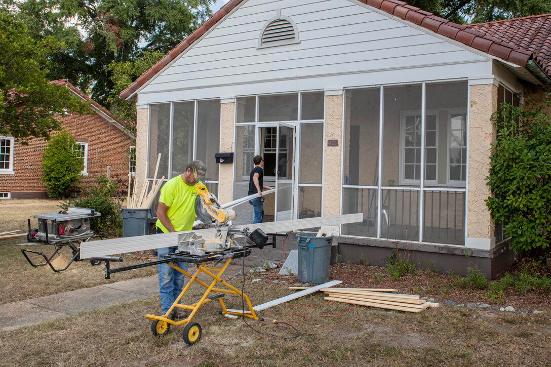 Workers install new windows at a historic home.
