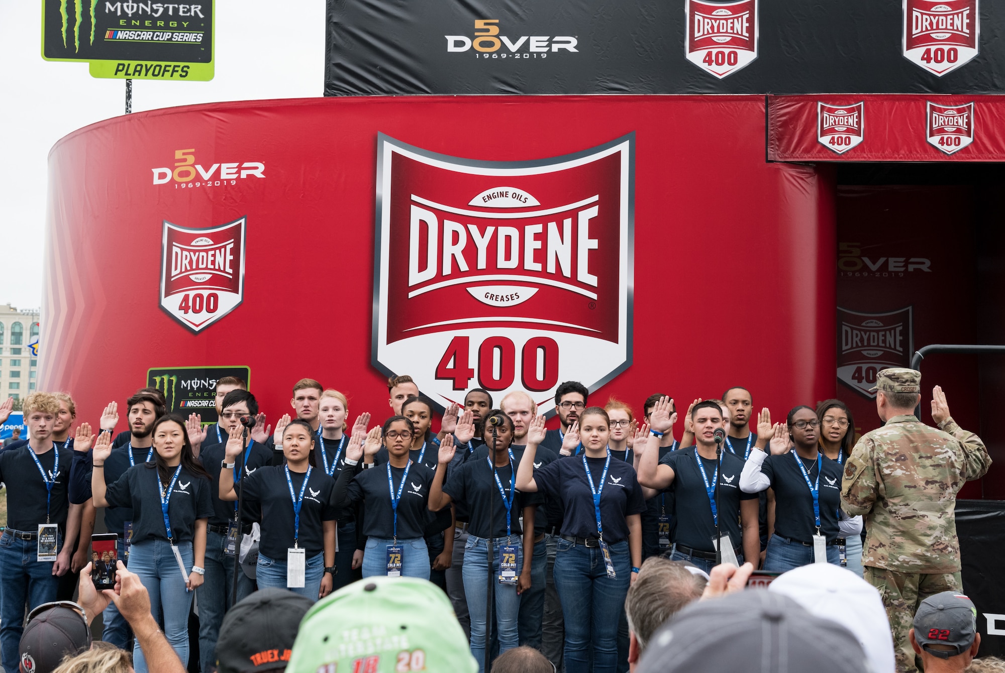 Maj. Gen. Clinton Crosier, assigned to the Deputy Chief of Staff for Strategy, Integration and Requirements, Headquarters U.S. Air Force, Arlington, Va., administers the oath of enlistment to 26 U.S. Air Force recruits entering the Delayed Entry Program Oct. 6, 2019, at Dover International Speedway, Dover, Del. Crosier administered the oath of enlistment to the recruits prior to the start of the "Drydene 400" Monster Energy NASCAR Cup Series playoff race. (U.S. Air Force photo by Roland Balik)