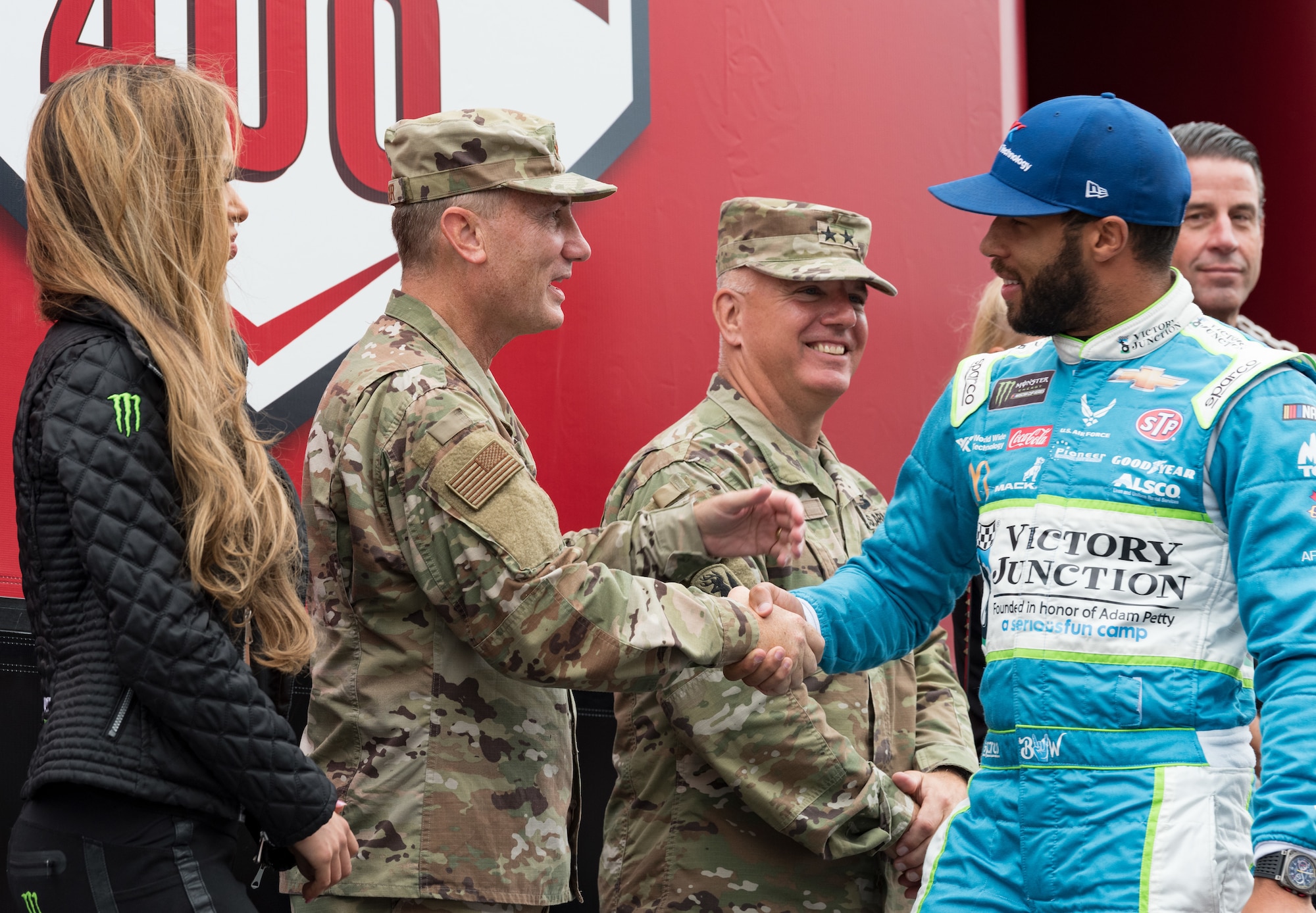 Maj. Gen. Clinton Crosier, assigned to the Deputy Chief of Staff for Strategy, Integration and Requirements, Headquarters U.S. Air Force, Arlington, Va., shakes hands with Bubba Wallace, driver of the No. 43 Victory Junction Chevrolet during driver introductions Oct. 6, 2019, at Dover International Speedway, Dover, Del. The U.S. Air Force is one of many sponsors of the No. 43 car that started in the 26th position for the "Drydene 400" Monster Energy NASCAR Cup Series playoff race. (U.S. Air Force photo by Roland Balik)