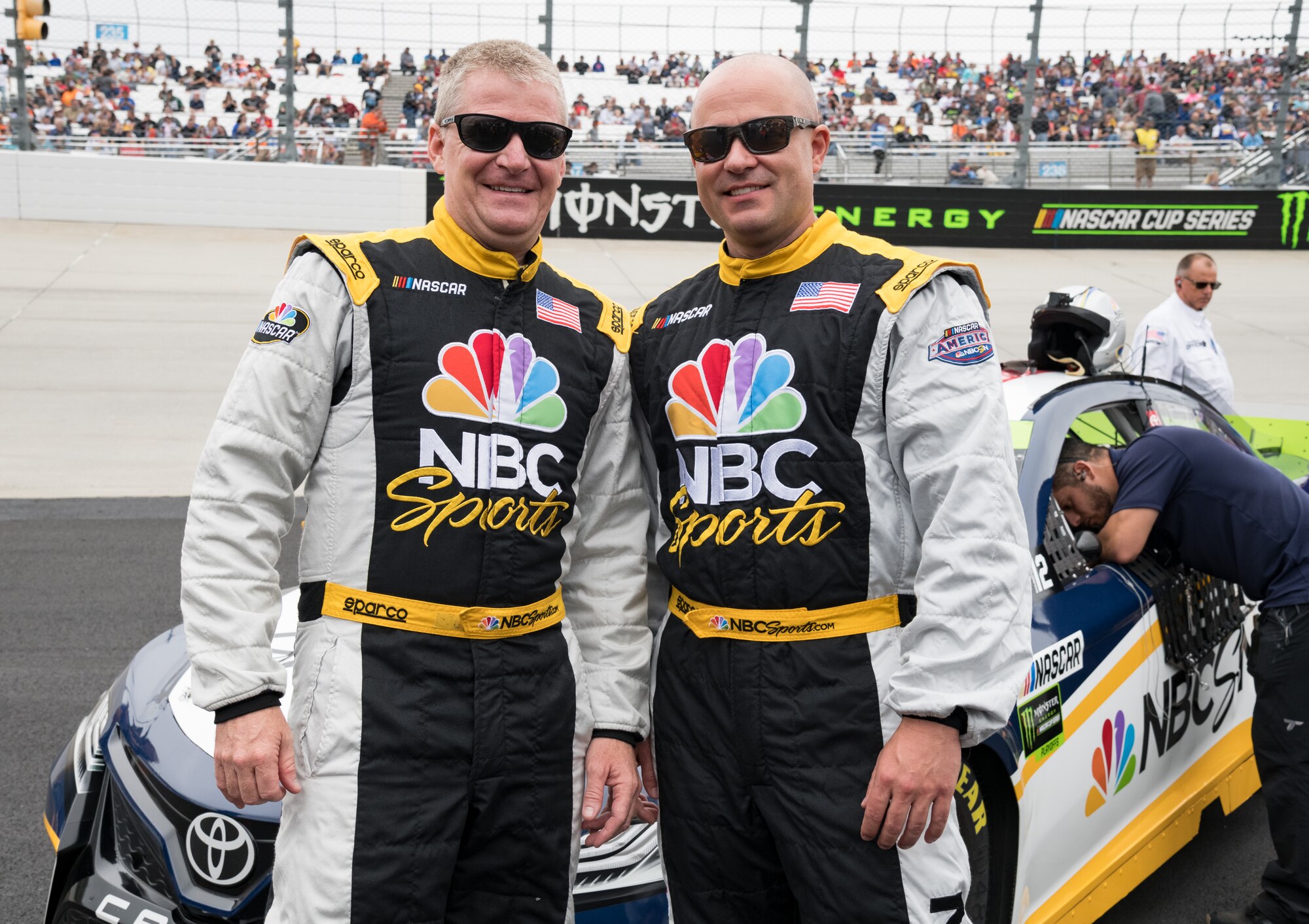 Jeff Burton, left, NBC Sports Group’s NASCAR Cup analyst, and Master Sgt. Chad Huggins, 436th Aerial Port Squadron combat readiness and resources section chief, pose for a photo Oct. 6, 2019, at Dover International Speedway, Dover, Del. Burton took Huggins for a “joy ride” in the NBC car at full speed around the Monster Mile, which was broadcasted live prior to the start of the “Drydene 400” Monster Energy NASCAR Cup Series playoff race. (U.S. Air Force photo by Roland Balik)