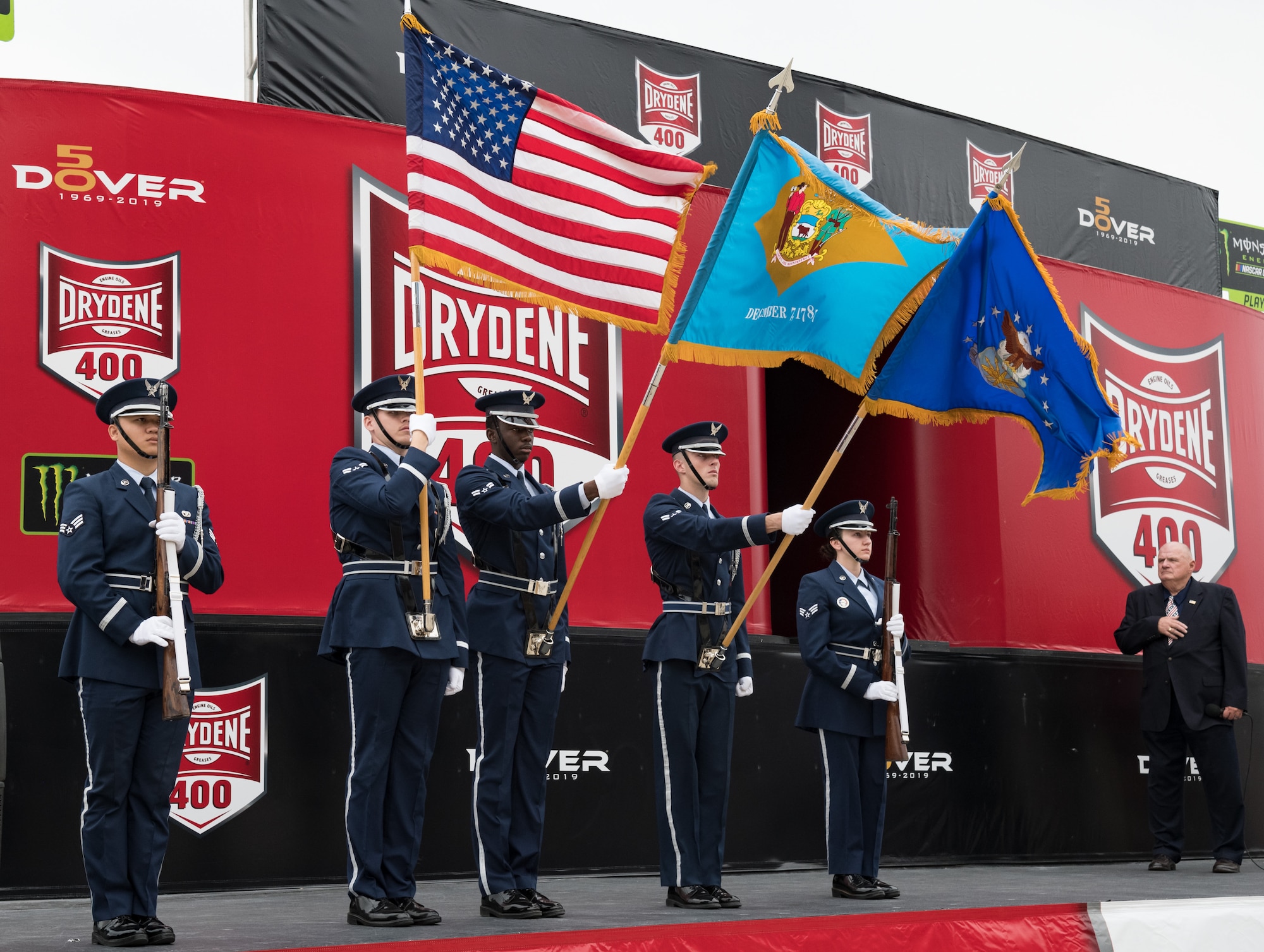 The Dover Air Force Base Honor Guard presents the colors during the opening ceremony of the "Drydene 400" Monster Energy NASCAR Cup Series playoff race Oct. 6, 2019 at Dover International Speedway, Dover, Del. Team Dover members participated in DIS's 50th Anniversary celebration and the 100th NASCAR Cup Series race in the track's history. (U.S. Air Force photo by Roland Balik)