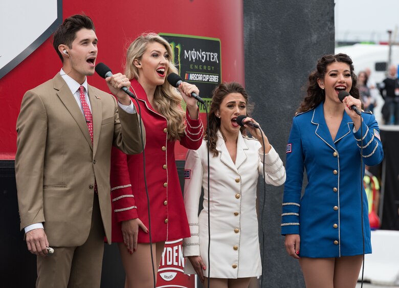 Members of the United Service Organizations Show Troupe sings the national anthem Oct. 6, 2019 at Dover International Speedway, Dover, Del. The troupe performed prior the start of the "Drydene 400" Monster Energy NASCAR Cup Series playoff race. (U.S. Air Force photo by Roland Balik)