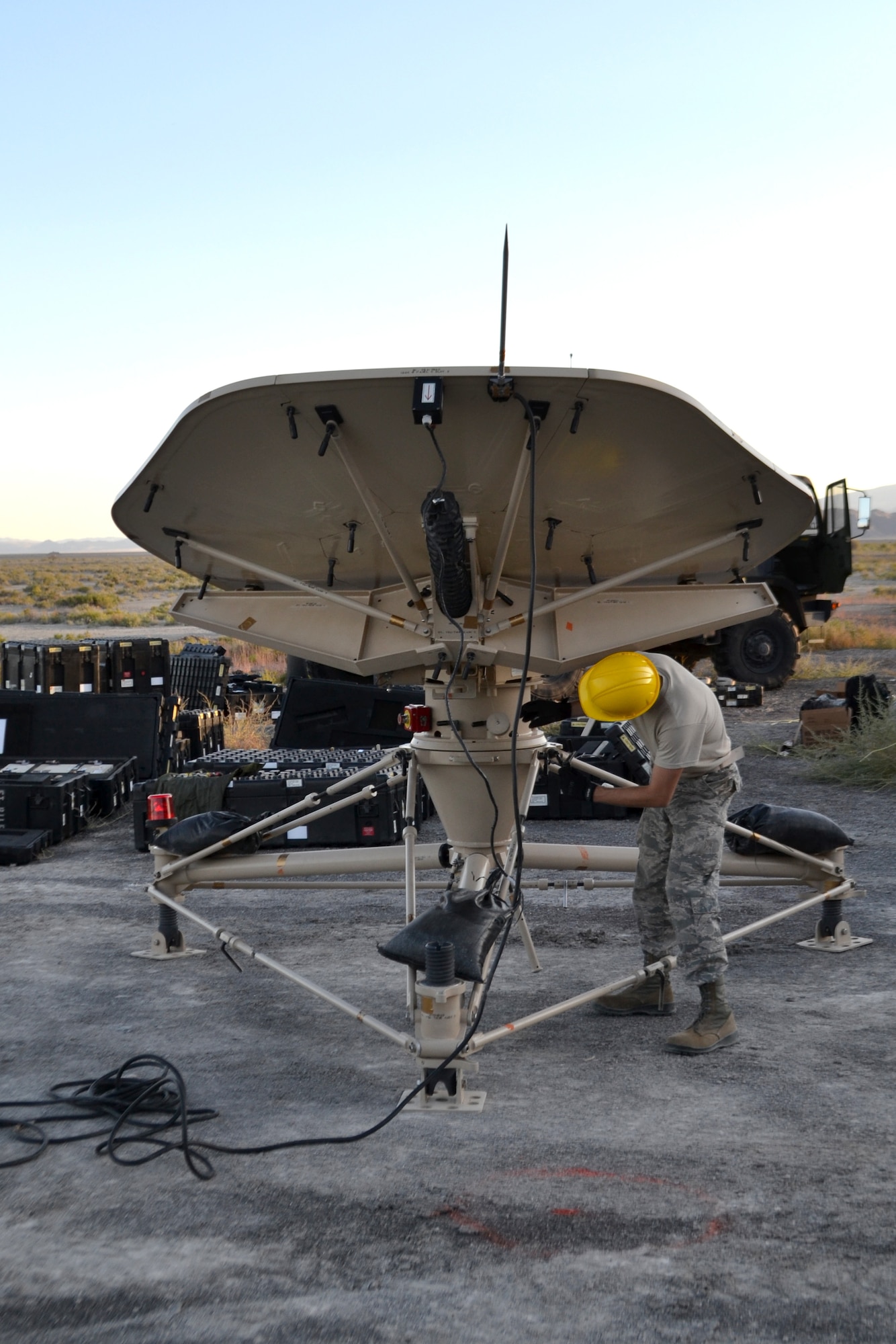 Airman 1st Class Jake Sevier, 729th Air Control Squadron, sets up a small aperture antenna at a base camp at Wendover Field, Utah. The Airmen were participating in the squadron’s annual Raging Bull exercise, where they set up a remote radar site to extend the unit's capability to control aircraft. (Courtesy photo by Master Sgt. Daniel Lane)