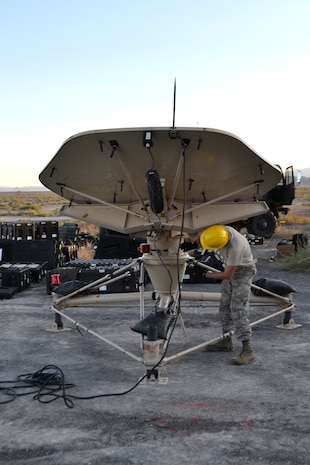 Airman 1st Class Jake Sevier, 729th Air Control Squadron, sets up a small aperture antenna at a base camp at Wendover Field, Utah. The Airmen were participating in the squadron’s annual Raging Bull exercise, where they set up a remote radar site to extend the unit's capability to control aircraft. (Courtesy photo by Master Sgt. Daniel Lane)