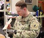 Sgt. 1st Class John C. Hoxie, assigned to U.S. Army South's Intelligence Operations Division at Joint Base San Antonio-Fort Sam Houston, conducts fine motor skills therapy at the Center for the Intrepid Sept.27. Hoxie was one of 23 service members to be recognized during the Outstanding Department of Defense Employee with a Disability Award during the 39th Annual Department of Defense Disability Awards ceremony Oct. 3 at the Pentagon, Washington, D.C.