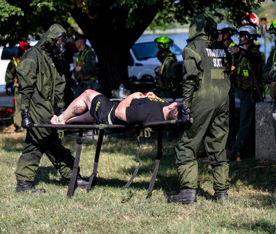 U.S. Marines with Chemical Biological Incident Response Force, carry a notional casualty during Capital Shield 19, on Fort McNair, District of Columbia, Sep. 4, 2019. Capital Shield is an exercise to train and prepare emergency responders in the National Capital Region for chemical exposure and response. (U.S. Marine Corps photo by Lance Cpl. Sarah N. Petrock)