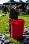 A U.S. Marine with Chemical Biological Incident Response Force, fills up a decontamination bucket with water during Capital Shield 19, on Fort McNair, District of Columbia, Sep. 4, 2019. Capital Shield is an exercise to train and prepare emergency responders in the National Capital Region for chemical exposure and response. (U.S. Marine Corps photo by Lance Cpl. Sarah N. Petrock)