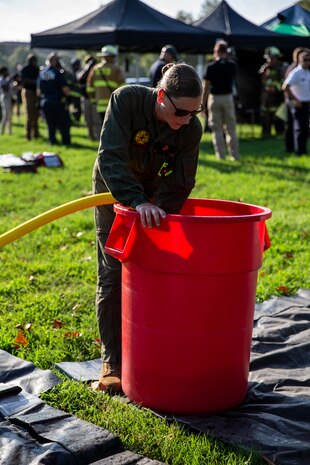 A U.S. Marine with Chemical Biological Incident Response Force, fills up a decontamination bucket with water during Capital Shield 19, on Fort McNair, District of Columbia, Sep. 4, 2019. Capital Shield is an exercise to train and prepare emergency responders in the National Capital Region for chemical exposure and response. (U.S. Marine Corps photo by Lance Cpl. Sarah N. Petrock)