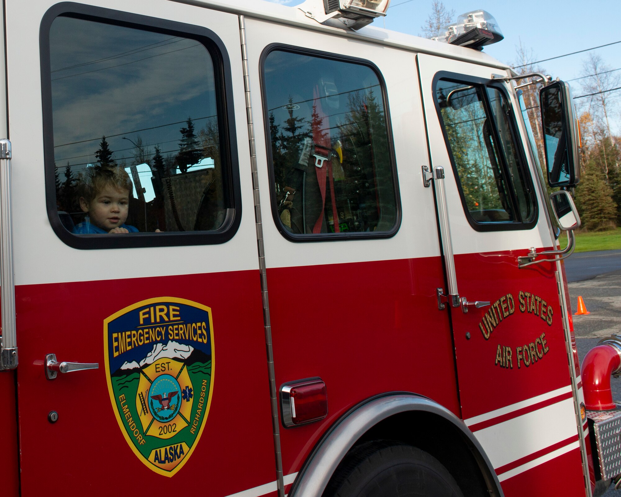 The child of U.S. Air Force Capt. Ryan McCluskey, a 962nd Airborne Air Control E-3 Sentry pilot, sits in a fire truck during a Joint Base Elmendorf-Richardson Fire and Emergency Services open house at Fire Station 3 on JBER, Alaska, Oct. 5, 2019. The open house kicked off this year’s Fire Prevention Week, a week to promote preparation for emergencies.
