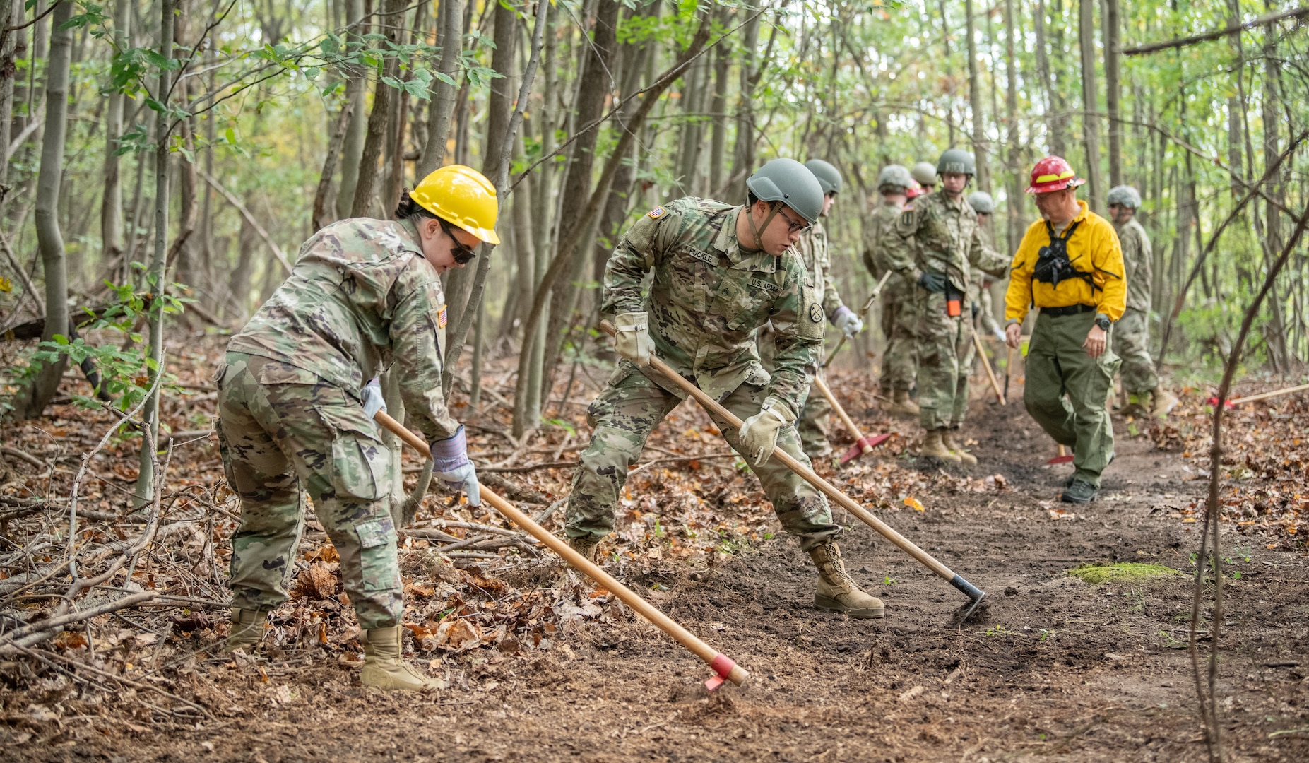 Soldiers of the West Virginia Army National Guard’s 249th Army Band work to remove debris from a fire line during basic wildland fire suppression training, conducted by the West Virginia Division of Forestry in Morgantown, West Virginia, Oct. 3, 2019. The training covered basic wildland fire fighting techniques including understanding fire behavior, suppression tactics and techniques, crew organization, communications, and crew safety and awareness, with the goal of providing WNVG Soldiers the basic skills and experience to operate on a fire line side-by-side with experienced Division of Forestry personnel. (U.S. Army National Guard photo by Edwin L. Wriston)