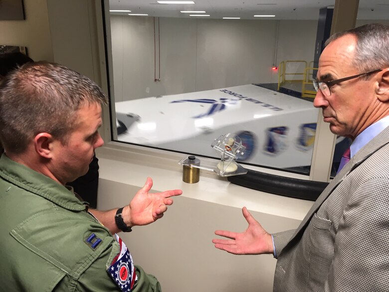 Capt. Adam Lohn, flight commander, Acceleration Branch, at the United States Air Force School of Aerospace Medicine, 711th Human Performance Wing’s Centrifuge training and research facility discusses current training program requirements with National Commission on Military Aviation Safety commissioner Gen. Raymond E. Johns, (USAF, Ret.) Sept. 11 during the commission’s visit to Wright-Patterson Air Force Base. The facility is the only human-rated centrifuge owned by the Department of Defense and provides training to approximately 1,200 students a year. (National Commission on Military Aviation Safety photo/Bryan Whitman)