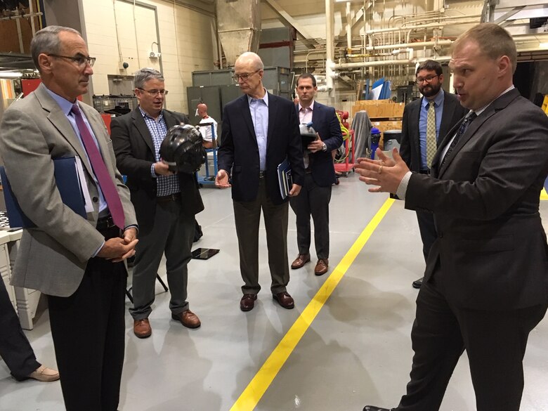 Dr. Casey Pirnstill, a research biomedical engineer at the 711th Human Performance Wing’s Horizontal Impulse Accelerator facility discusses human performance research done at the facility with National Commission on Military Aviation Safety commissioner Gen. Raymond E. Johns, (USAF, Ret.) and other commissioners. The commissioners visited Wright-Patterson Air Force Base Sept. 11-12. (National Commission on Military Aviation Safety/Bryan Whitman)