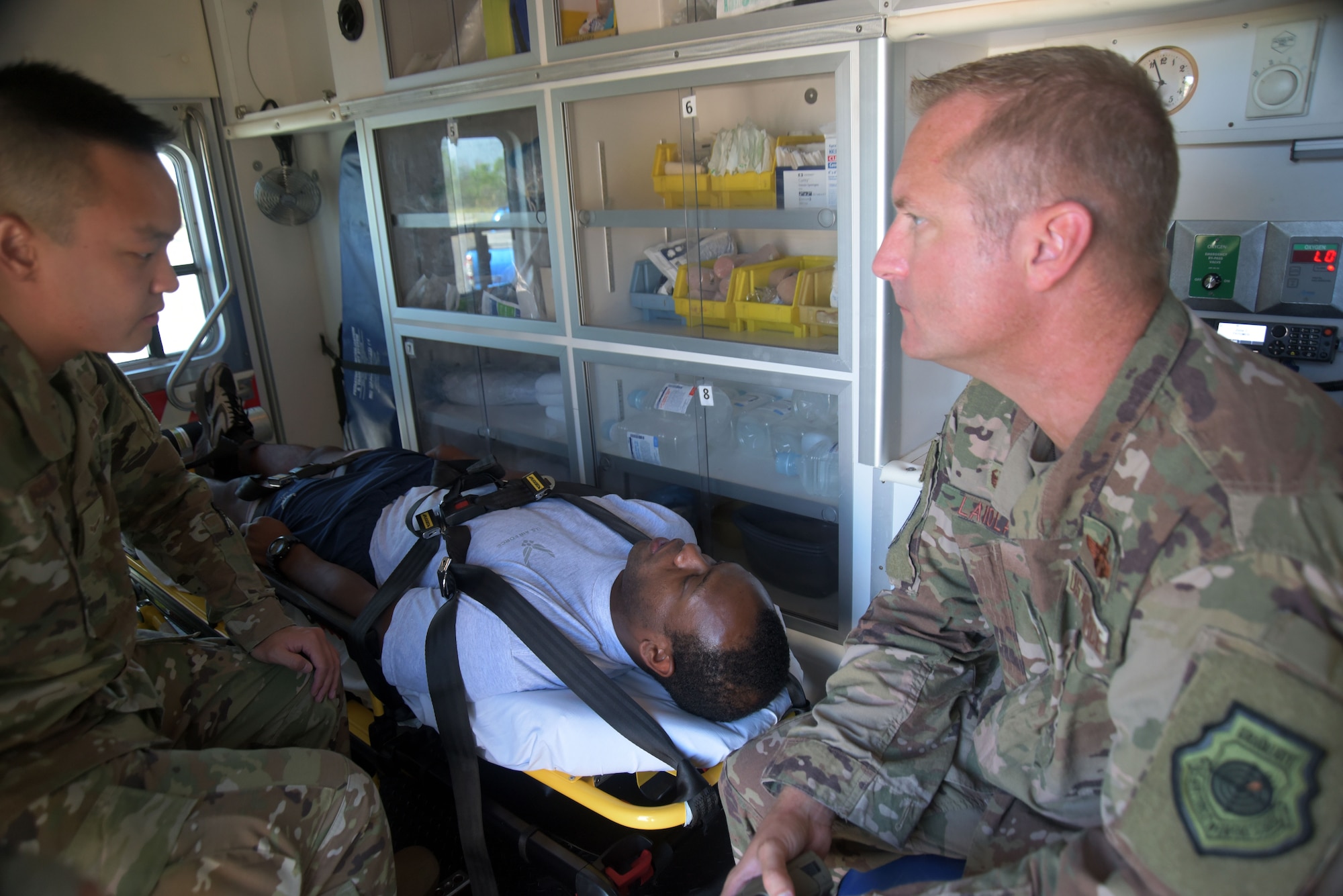 Airman 1st Class Brian Nguyen, 325th Operational Medical Readiness Squadron Ambulance Services Department medic, left, and Col. Brian Laidlaw, 325th Fighter Wing commander, right, care for a patient in a simulated medical response scenario Oct. 4, 2019, at Tyndall Air Force Base, Florida. Nguyen was hand selected to represent the 325th Medical Group for the commander’s Airman Shadow Program, which aims to give the commander a first-hand view of what Airmen do on the job. (U.S. Air Force photo by Staff Sgt. Magen M. Reeves)