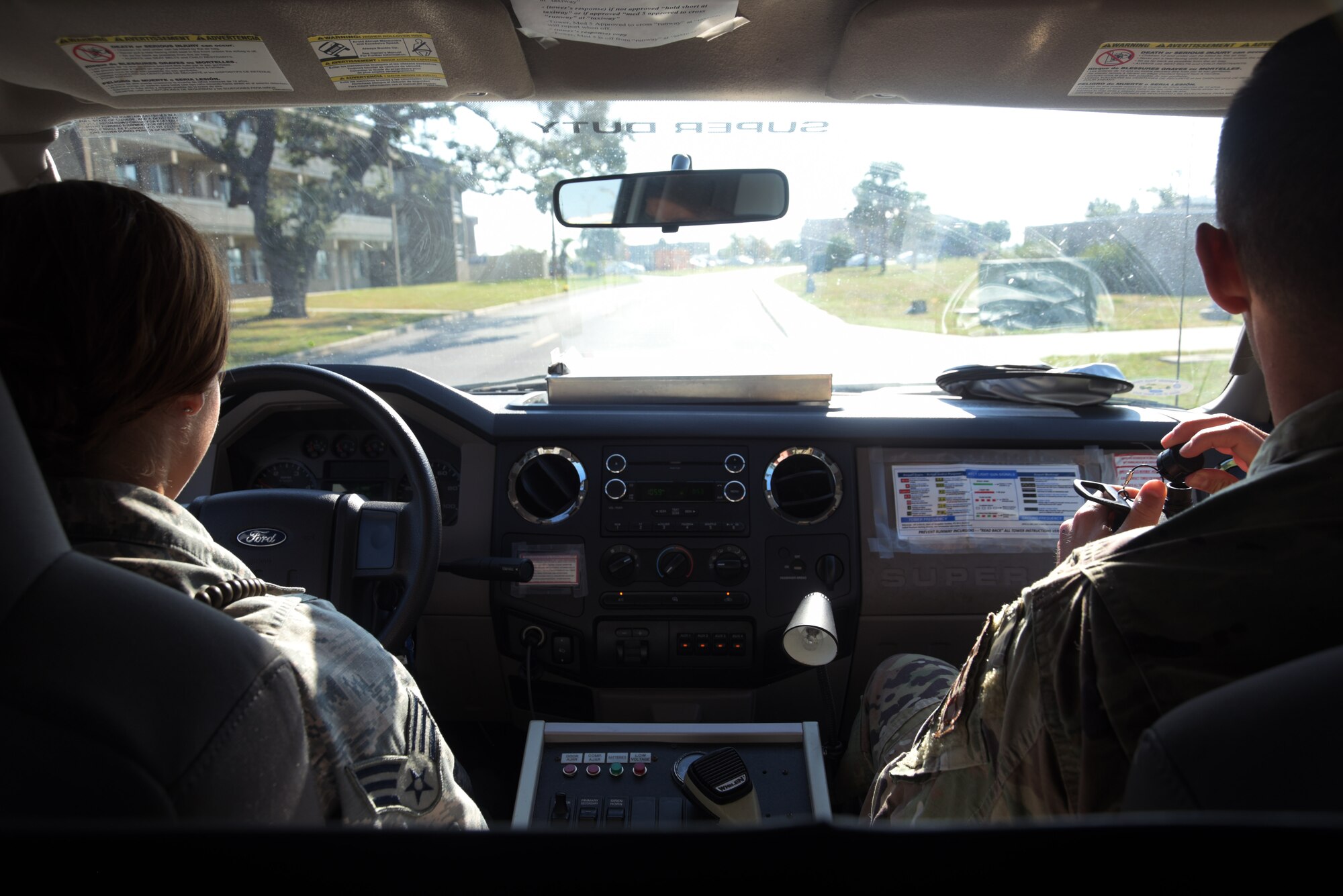 Senior Airman Deliz Aguilera, left, and 1st Lt. Chase Walker, 325th Operational Medical Readiness Squadron Ambulance Services Department medics, head out to an emergency medical response exercise Oct. 4, 2019, at Tyndall Air Force Base, Florida. The 325th OMRS had initiated a simulation to practice response, transportation, and providing basic emergency medical service when patient care is needed for heat exhaustion. (U.S. Air Force photo by Staff Sgt. Magen M. Reeves)