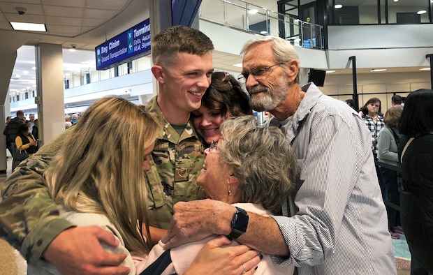 Staff Sgt. Braxton Beckstead, a reservist in the 67th Aerial Port Squadron, hugs his family goodbye before departing on a deployment to the Middle East last week