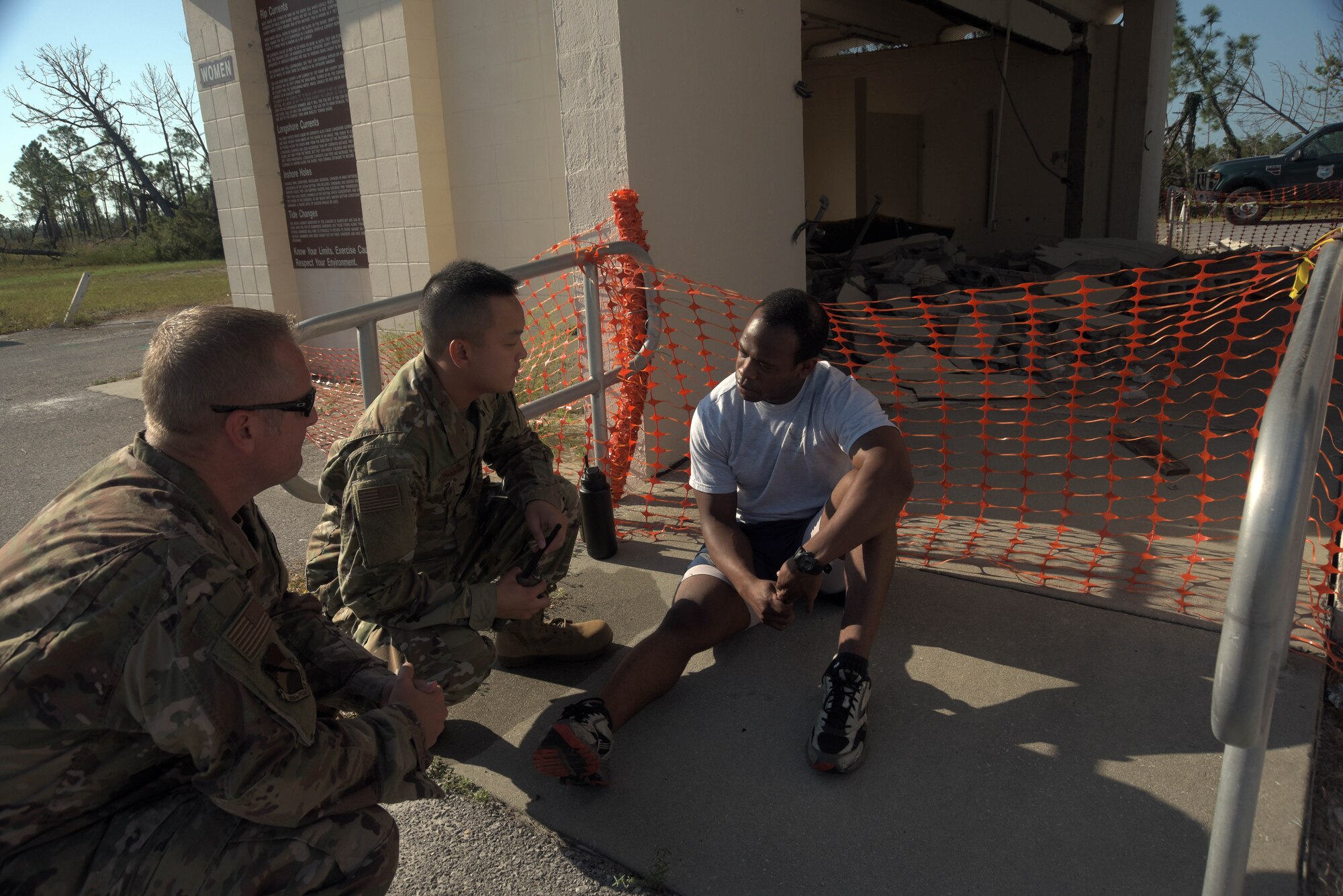 Col. Brian Laidlaw, 325th Fighter Wing commander, left, Airman 1st Class Brian Nguyen, center, and Senior Airman Zachary Collins, 325th Operational Medical Readiness Squadron Ambulance Services Department medics, participate in an emergency medical response exercise Oct. 4, 2019, at Tyndall Air Force Base, Florida. The 325th OMRS had initiated a simulation to practice response, transportation, and providing basic emergency medical service when patient care is needed for heat exhaustion to give the wing commander a first-hand experience of on the job procedures. (U.S. Air Force photo by Staff Sgt. Magen M. Reeves)