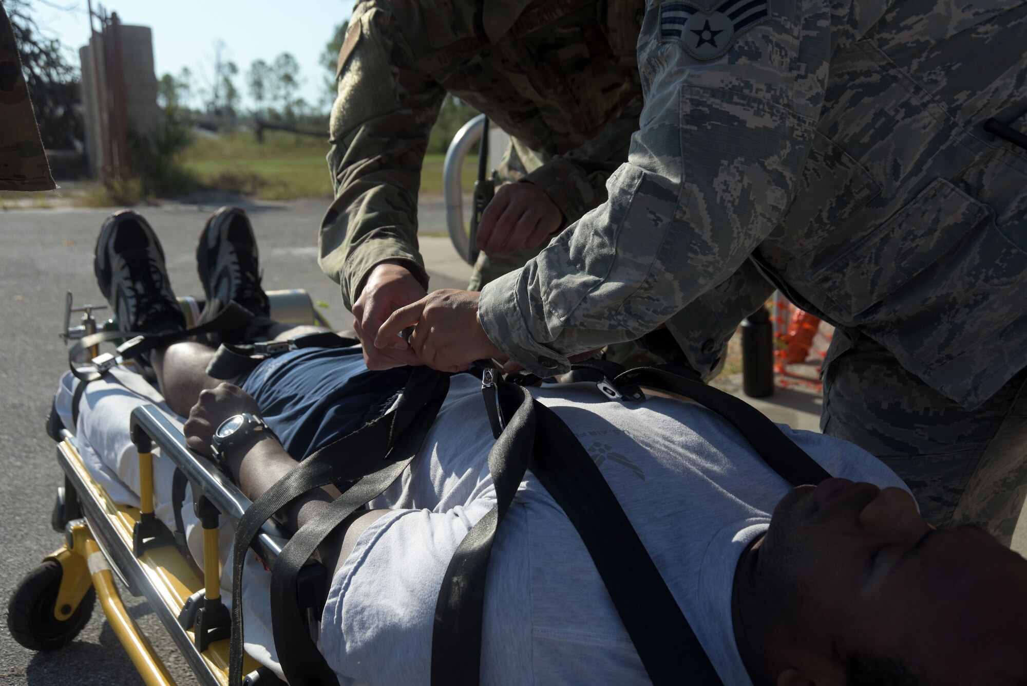 Airman 1st Class Brian Nguyen, left, and Senior Airman Deliz Aguilera, right, 325th Operational Medical Readiness Squadron Ambulance Services Department medics secure a patient during an emergency medical response exercise Oct. 4, 2019, at Tyndall Air Force Base, Florida. Patients in need of medical transportation are seat belted safely to a stretcher and loaded into an ambulance to provide the safest and fastest transit to the proper facility. (U.S. Air Force photo by Staff Sgt. Magen M. Reeves)