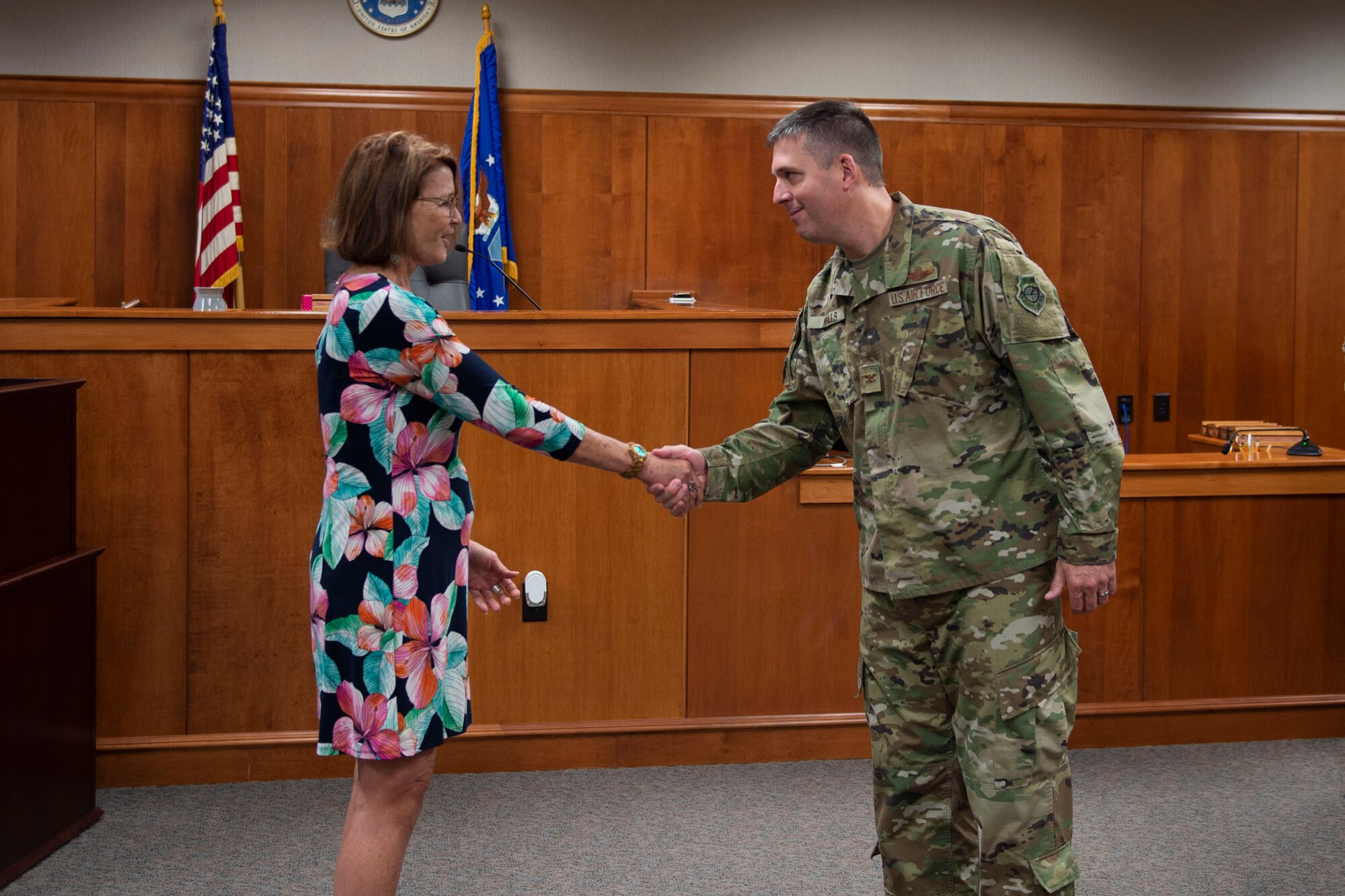Col. Daniel Walls, right, 23d Wing commander, coins Alisa James, 23d Wing Judge Advocate chief of civil law, Oct. 7, 2019, at Moody Air Force Base, Ga. James was recognized for being the lead air show legal advisor and having 21 legally sufficient removals, suspensions and reprimands. Walls visited different components of Moody’s Wing Staff Agency to acknowledge their contributions to the mission. (U.S. Air Force photo by Airman Azaria E. Foster)