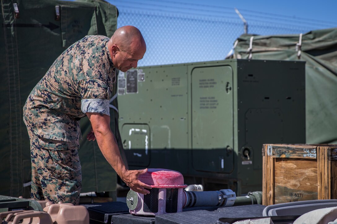 U.S. Marine Corps GySgt Joseph Chinea, the Utilities Chief for Utilities Platoon, Engineer Operation Company, Marine Wing Support Squadron (MWSS) 371, checks over equipment on Canon Air Defense Complex Yuma, Az., Oct 3, 2019. As the Utilities Chief, GySgt Chinea is the technical advisors to the commander on the employment of utilities support in order to analyze, translate, and execute the commanders operational requirements into a utilities support reality that enhances mission accomplishment. (U.S. Marine Corps photo by Lance Cpl. John Hall)