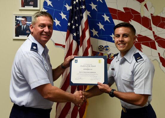 U.S. Air Force Lt. Col. Herbert Millet, 313th Training Squadron commander, presents the 315th Training Squadron Officer Student of the Month award to 2nd Lt. William Chirinos, 315th TRS student, at Brandenburg Hall on Goodfellow Air Force Base, Texas, Oct. 4, 2019. The 315th TRS’s vision is to develop combat-ready intelligence, surveillance and reconnaissance professionals and promote an innovative squadron culture and identity unmatched across the U.S. Air Force. (U.S. Air Force photo by Airman 1st Class Zachary Chapman/Released)