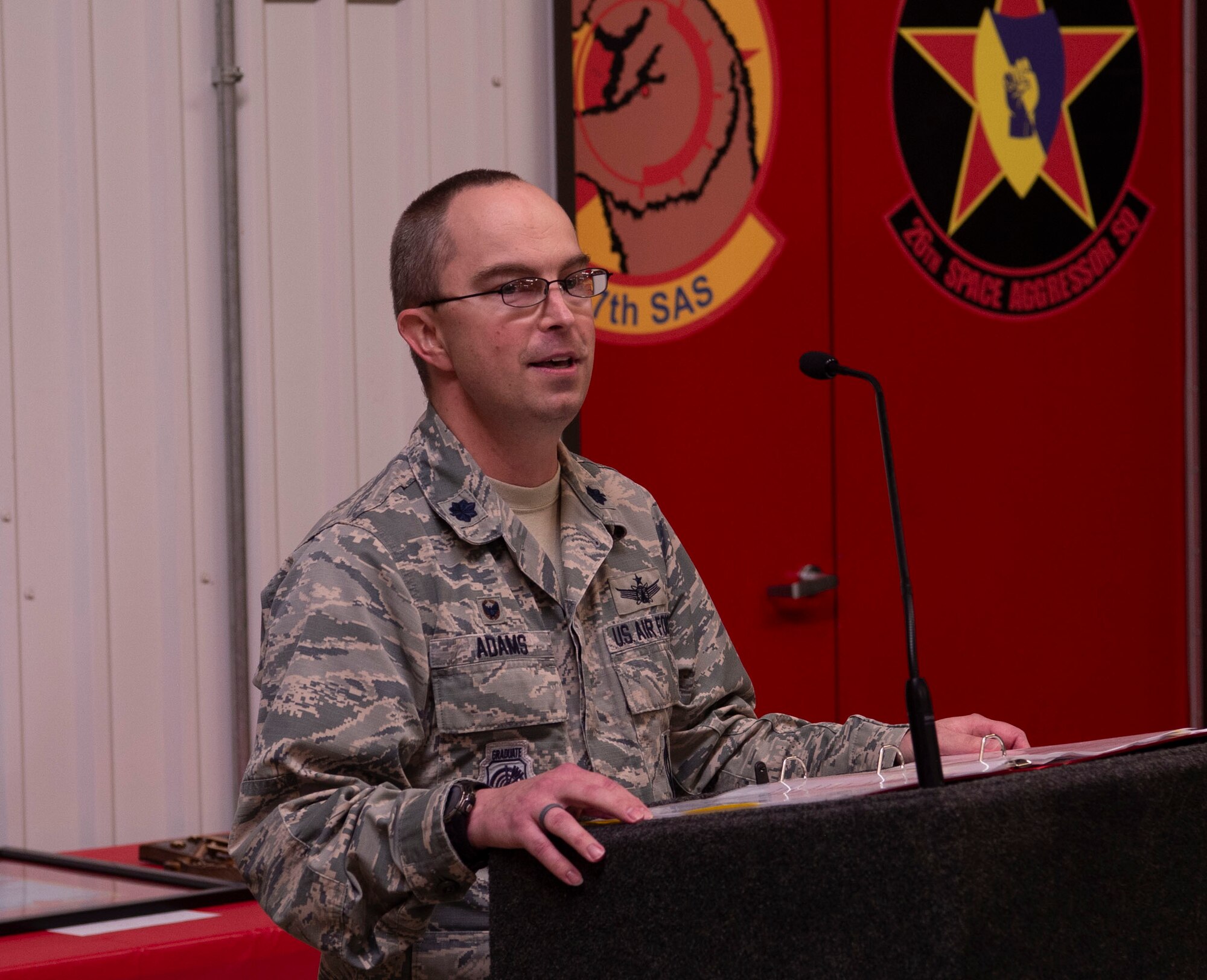 Lt. Col. Jason Adams, 527th Space Aggressor Squadron commander, provides remarks during the 4th Space Company Detachment 4, 1st Space Battalion end-of-mission ceremony at the 527th SAS barn, Schriever Air Force Base, Colorado, Sept. 27, 2019. The 527th SAS is a mission partner on Schriever AFB and is responsible for preparing friendly forces for operating in adversarial environments by examining, training and reproducing real-time, space threats for friendly forces to train against. (U.S. Air Force photo by Staff Sgt. Matthew Coleman-Foster)