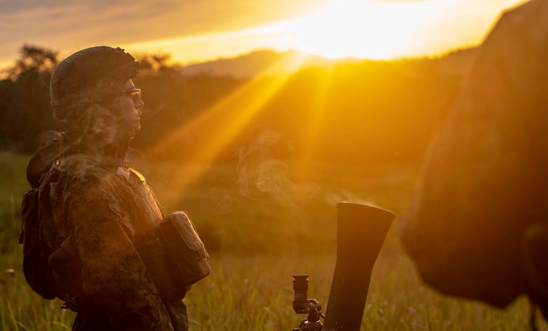 191004-M-QR315-1158 MALAYSIA (Oct. 04, 2019) U.S. Marine Corps Lance Corporal RaGarreh Rivera, a mortarman attached to Lima company, 11th Marine Expeditionary Unit (MEU), observers an illumination round fired from an 81mm mortar system during a call for fire exercise. Malaysian Armed Forces were joined by U.S. Marines and Sailors for exercise Tiger Strike 2019 where both forces participated in jungle survival, amphibious assault, aerial raids, and combat service support training and cultural exchanges (U.S. Marine Corps photo by Sgt. Matthew Teutsch)