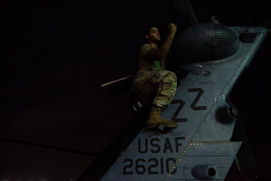 U.S. Air Force Senior Airman Andre Butler, 33rd Rescue Squadron crew chief, checks the tail of an HH-60 Pave Hawk Sept. 19, 2019, at Kadena Air Base, Japan. The HH-60 Pave Hawk has a hoist capable of lifting up to 600 pounds during personnel recovery missions. (U.S. Air Force photo by Senior Airman Rhett Isbell)