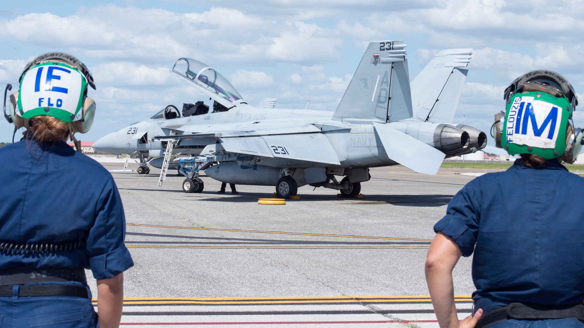 Petty Officer 2nd Class Michelle Flores, a Strike Fighter Squadron (VFA) 106 aviation electrician, and Petty Officer 2nd Class Erika Felouzis, a VFA-106 aviation mechanic from Naval Air Station Oceania, Va., monitor the flight line at MacDill Air Force Base, Fla., Oct. 3, 2019.