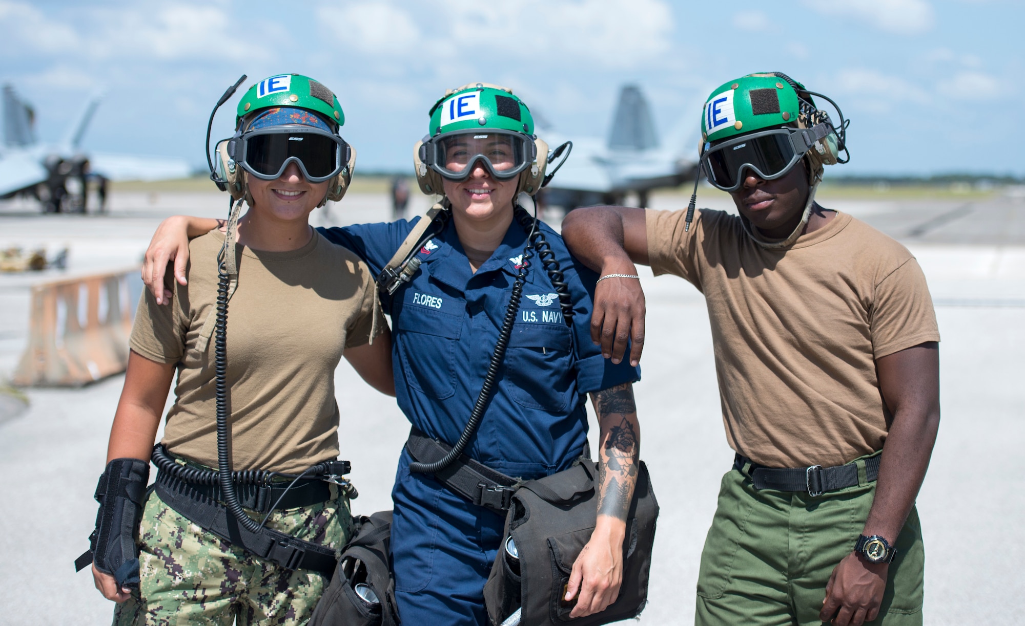 Three U.S. Navy Strike Fighter Squadron 106 aviation mechanics from Naval Air Station Oceania, Va., pause for a photo at MacDill Air Force Base, Fla., Oct. 1, 2019.