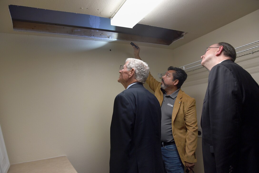 An image of Congressional and Air Force leaders reviewing the housing situation on Tinker Air Force Base.