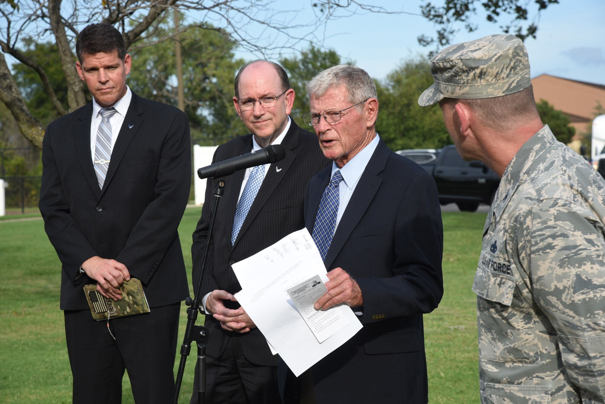 An image of Air Force and Congressional leaders giving a press conference following their review of houses on Tinker Air Force Base.