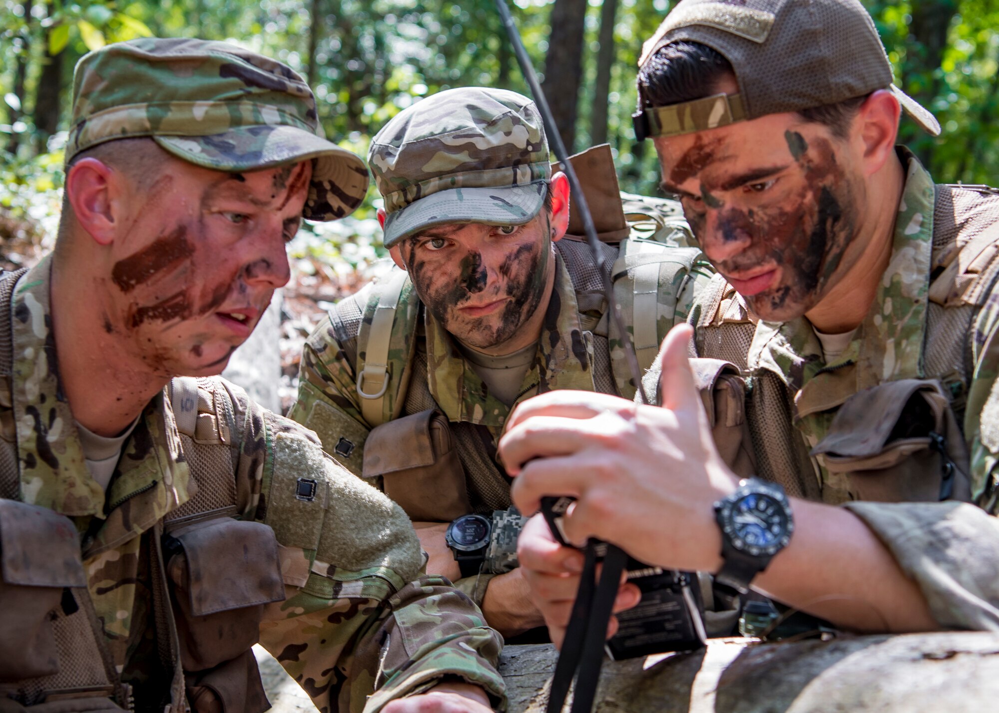 U.S. Air Force Capt. Logan Hawke, a pilot assigned to the 16th Airlift Squadron, U.S. Air Force Master Sgt. William Davis and U.S. Air Force Staff Sgt. Randall Moss, loadmasters assigned to the 16th Airlift Squadron, communicate with rescue forces with a radio during a survival, evasion, resistance, and escape exercise August 21, 2019, in North, South Carolina. SERE specialists assigned to the 437th Operations Support Squadron conducted this exercise in order to identify potential areas of improvement in both SERE training and equipment provided to aircrew in case of a potential isolating event. (U.S. Air Force photo/Airman 1st Class Duncan C. Bevan)