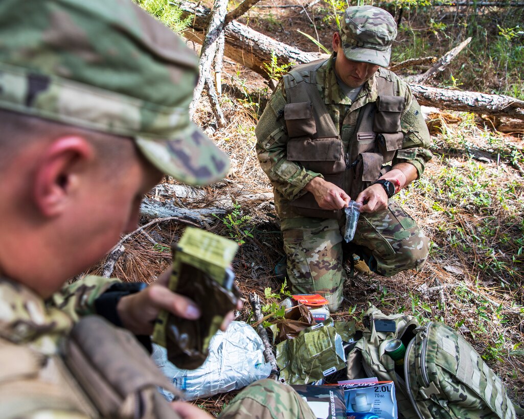 U.S. Air Force Staff Sgt. Randall Moss and U.S. Air Force Master Sgt. William Davis, loadmasters assigned to the 16th Airlift Squadron, sort through survival equipment during a survival, evasion, resistance, and escape exercise August 21, 2019, in North, South Carolina. SERE specialists assigned to the 437th Operations Support Squadron conducted this exercise in order to identify potential areas of improvement in both SERE training and equipment provided to aircrew in case of a potential isolating event. (U.S. Air Force photo/Airman 1st Class Duncan C. Bevan)