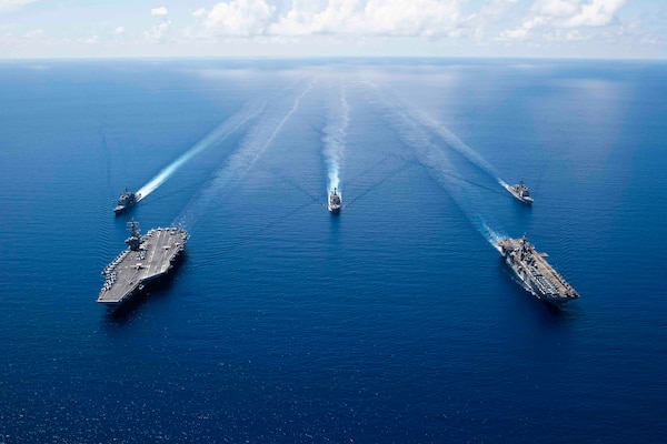 A group of ships sail in formation.