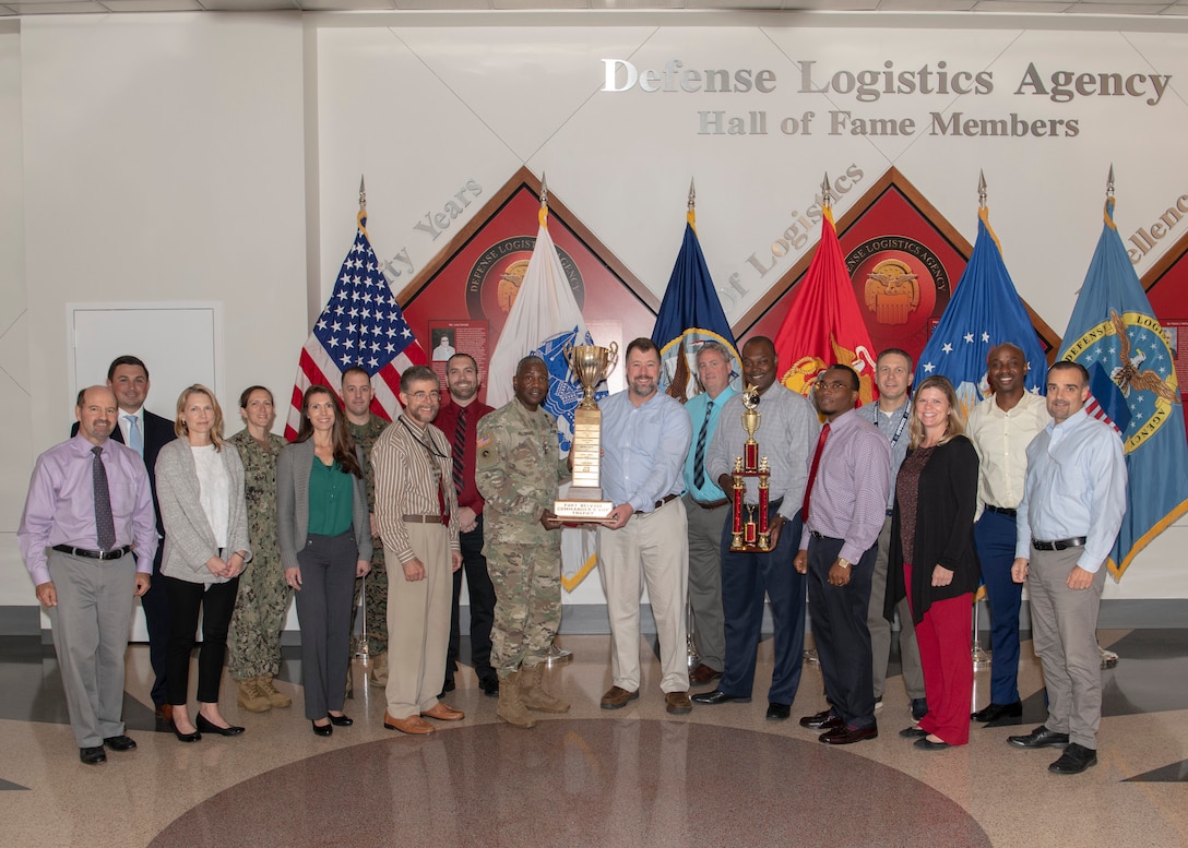 Members of Team DLA, 2019 Fort Belvoir Commander's Cup champions, pose with DLA Director Army Lt. Gen. Darrell Williams (center). Also holding the trophy is Andrew Green of DLA Strategic Materials, who organized DLA's participation in the events throughout the year. This is the second year in a row DLA has won, beating out teams from across Fort Belvoir. Photo by Teodora Mocanu