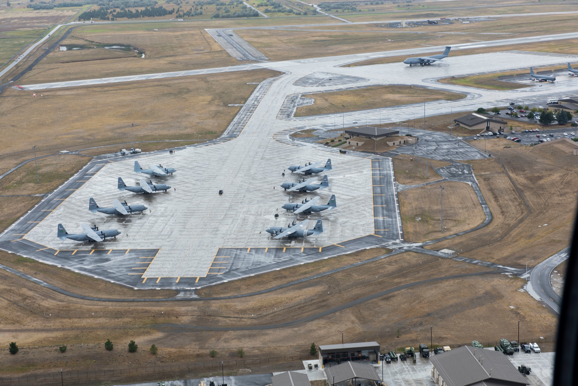 C-130s sit on the flight line.
