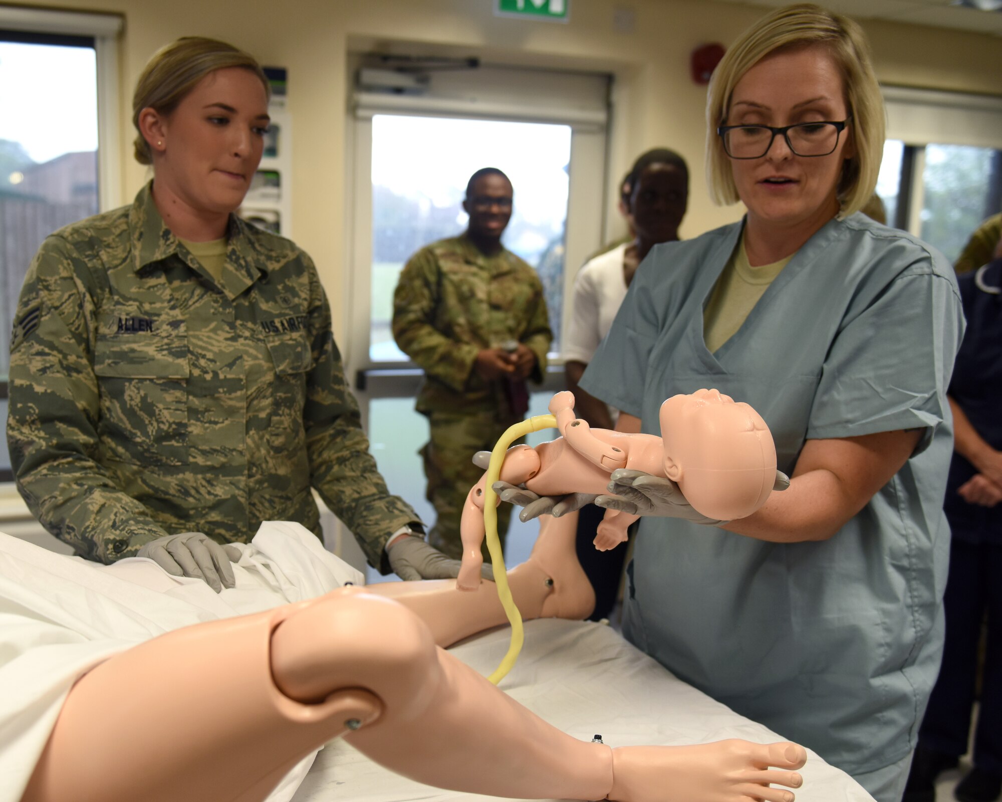 48th Medical Group Airmen from the Labor and Delivery unit demonstrate delivery techniques to U.K. National Health Service partners during an immersion tour at Royal Air Force Lakenheath, England, Oct. 4, 2019. NHS medical personnel visited the Liberty Wing to gain knowledge and insight of the base’s medical training simulation capabilities. (U.S. Air Force photo by Airman 1st Class Rhonda Smith)