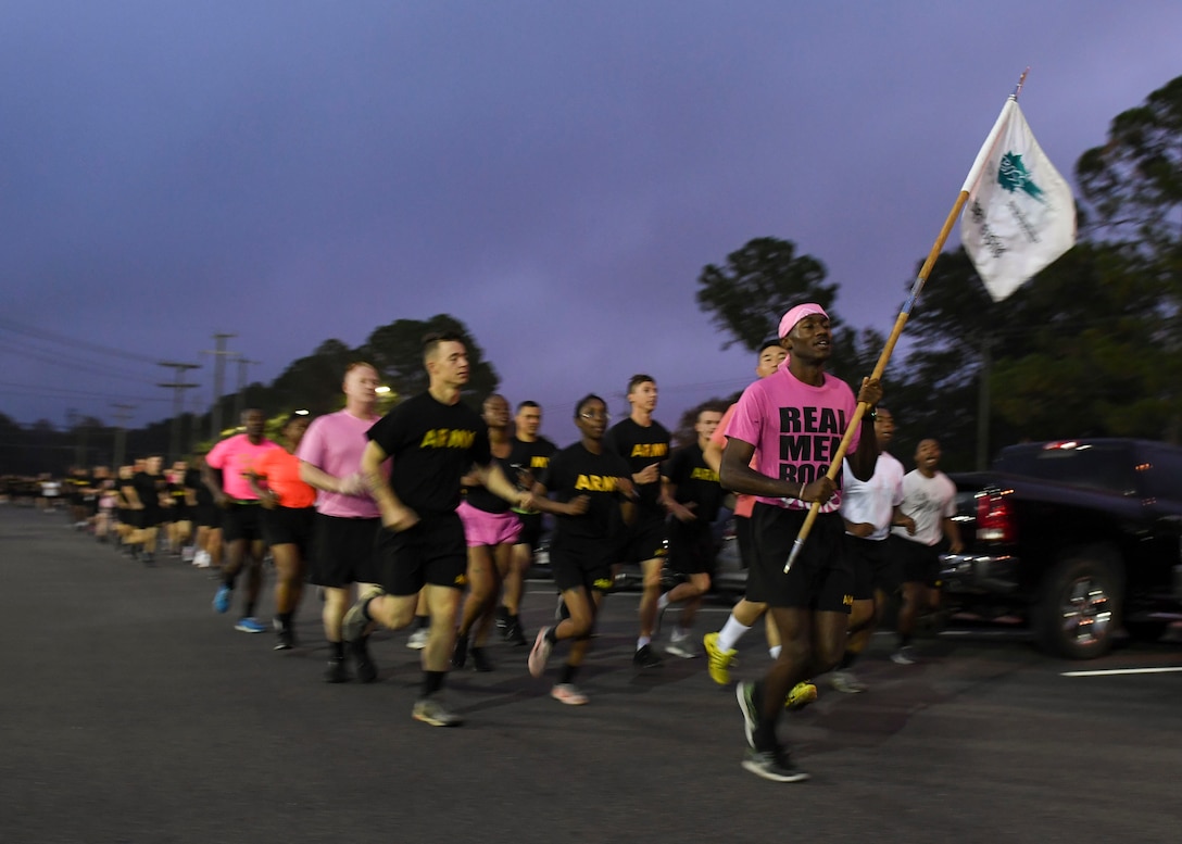 U.S. Army Pfc. Jalen Scott, Headquarters and Headquarters Company unit supply specialist, leads Soldiers during a Breast Cancer Awareness 5K run at Joint Base Langley-Eustis, Virginia, Oct. 4, 2019.