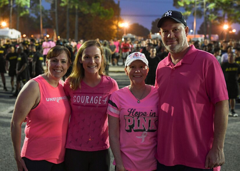 Christine Stiefel, Army Community Service school liaison (left), Kimberly Lawrence, Marie Lawrence and retired Navy Lt. Robert Lawrence (right), pose for a photo during a Breast Cancer Awareness 5K run at Joint Base Langley-Eustis, Virginia, Oct. 4, 2019.