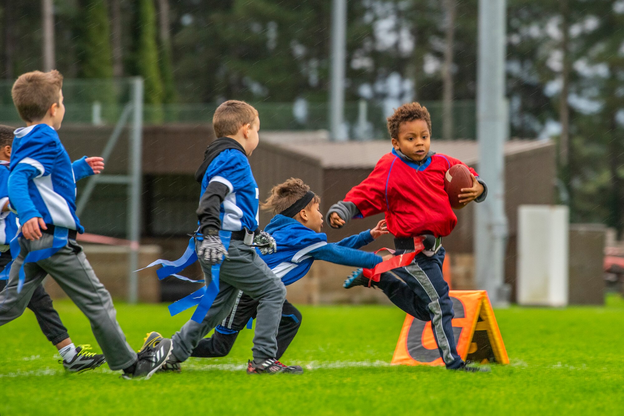 A flag football player sprints to avoid losing his flag at Heritage Park Oct. 7, 2019, at RAF Mildenhall, England. The park reopened following a six-month renovation. (U.S. Air Force photo by Airman 1st Class Joseph Barron)